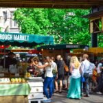 Lively scene at Borough Market in London, filled with people shopping and enjoying the atmosphere.